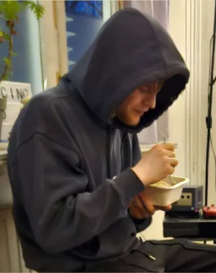 Telmö on campus, alone in his hoodie